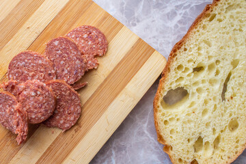 Top view of sliced sucuk and bread on table