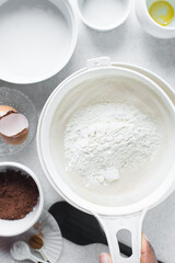 Sifting flour for baking, a plastic sieve with flour in it