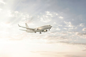 Fototapeta na wymiar Passengers commercial airplane flying in sunrise light