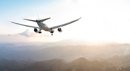 Passengers commercial airplane flying above mountains