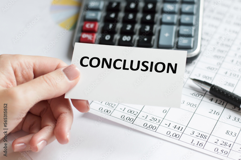 Poster conclusion text on a card in the hands of a businessman on the background of a table with documents