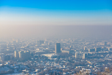 View of the city Almaty from above during the smog in winter. Kazakhstan - 565319625