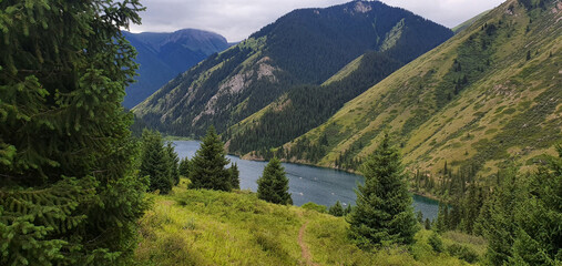 Mountain landscape with a path and a lake in the Carpathians