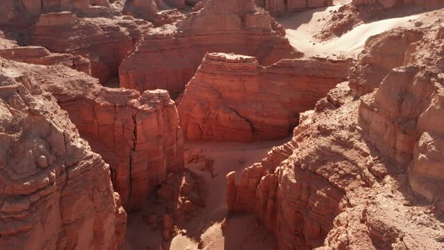 Cinematic aerial flyover of red rock formation in canyon desert Gobi.
