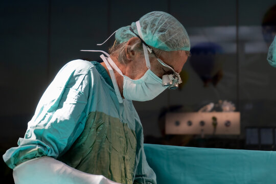 Open heart surgery, doctors and cardiologists perform open heart surgery. Doctors in green uniforms in the operating room.