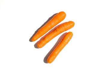 Fresh carrots on a white background. Top view, flat lay