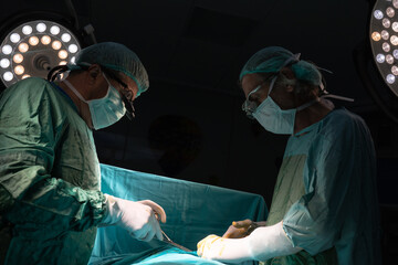 Open heart surgery, doctors and cardiologists perform open heart surgery. Doctors in green uniforms...