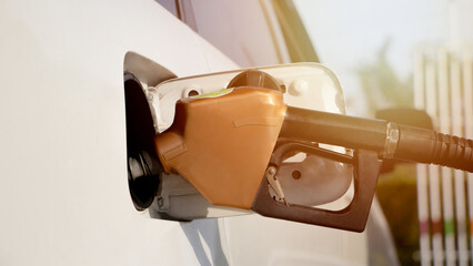 Close-up shot of fuel monitoring system refueling from petroleum to fuel price vehicle at gas...