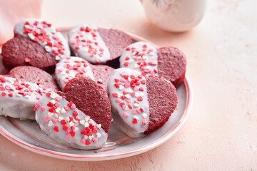 Red velvet or brownie cookies on heart shaped in chocolate icing on a pink romantic background. Dessert idea for Valentines Day, Mothers or Womens Day. Tasty homemade dessert. Cake for Valentines Day