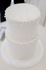Fototapeta na wymiar White wedding cream cake with pearls