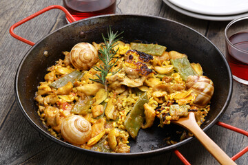 traditional Valencian paella in Spain; rabbit, chicken, garrofon beans, snails, Moroccan green...