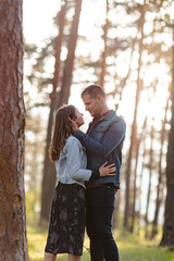 Happy partners on a getaway kissing, smiling and relaxing outdoors enjoying and loving the sunlight