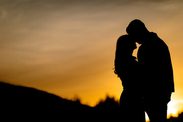 Silhouettes of a tender couple at sunset