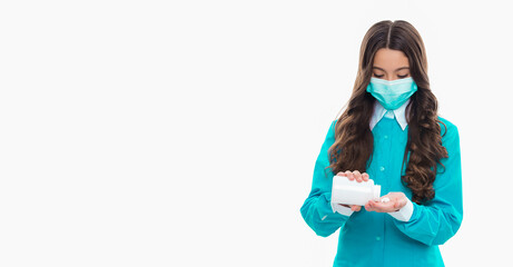 doctor girl taking medication pills, copy space. doctor girl in mask with medication pills