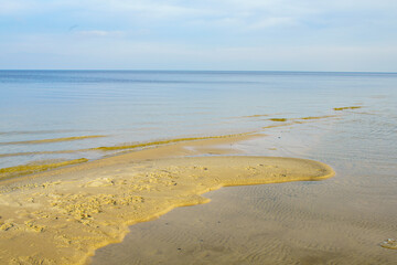 Natural background, sandy shore and water.
