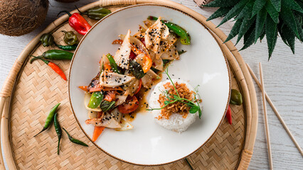 Stewed squid, onion, tomatoes, sweet pepper in teriyaki sauce with rice, sesame and herbs.