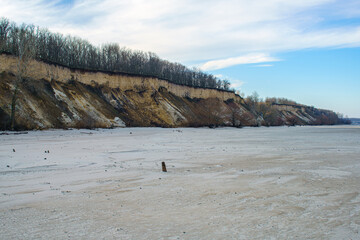 Natural landscape, cliff and sandy bank of the river.