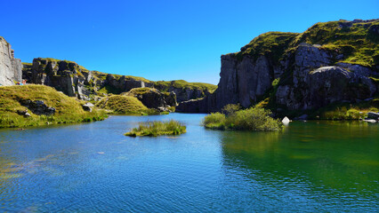 Fototapeta premium blue mountain lake between rocks and hills
