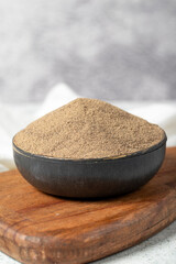 Black pepper spice. Ground black pepper spice on stone background. Dry spice concept. close up