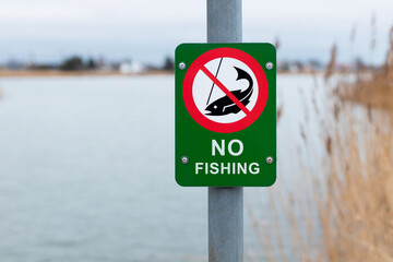 Fishing prohibited sign near lake - NO FISHING