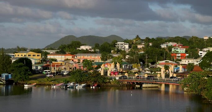 St Lucia Castries Caribbean cruise ship flag city marina bridge. British Commonwealth Island. Cruise ship vacation destination. National capital city of Castries. Yacht, cargo, sailboat harbor marina.