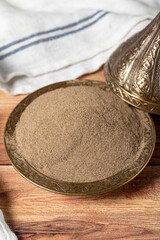 Black pepper spice. Ground black pepper spice in bowl on wood floor. Dry spice concept. close up