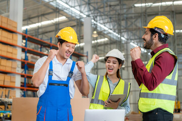 Happy employees celebrating together at warehouse