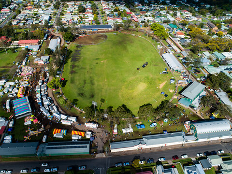 Aerial view of the showring and sideshow alley at agricultural show fairground while the show is on