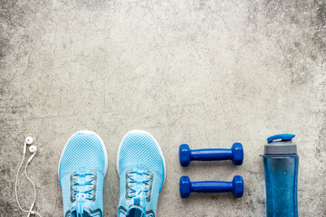 Sport fitness flatlay with sneakers and dumbbells, top view