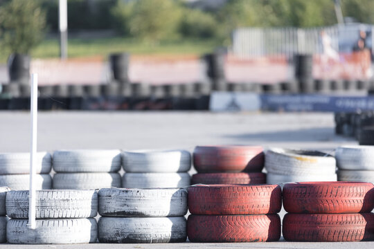 Tire barriers on asphalt along karting track