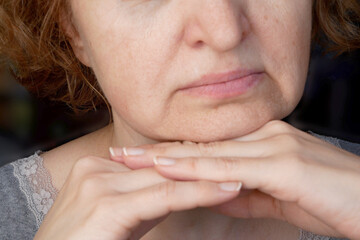 body language, the woman's head rests on crossed arms - the woman flaunts, wants to please, flirting Closeup