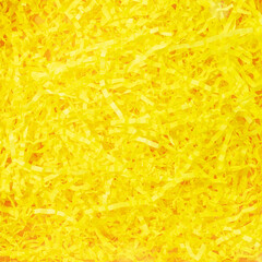 Texture of yellow paper filler. Shredded Paper Packing Material. Sunny yellow spaghetti shredded packing paper used to protect fragile object while in transport. Backgrounds and Texture. Flat lay