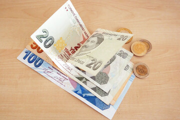 Many Turkish Lira Banknotes with coins on wooden desk. money banknotes pack.