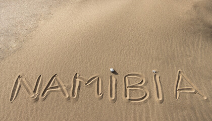 "Namibia" written in the sand of the desert