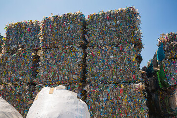Big pile of waste plastic bottles in the factory to wait for recycling.