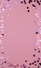heart shaped confetti on pink paper