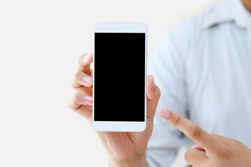 Hand holding blank screen phone or smartphone or tablet for template on white background.