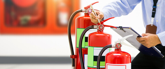 Fire safety engineering services inspection checking pressure gauges of fire extinguisher fire...