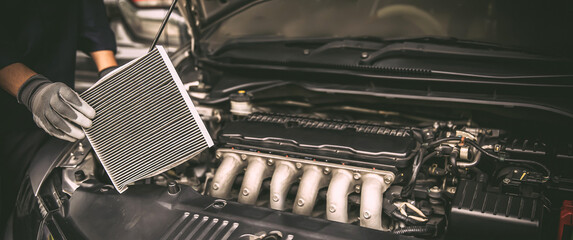 Car air conditioner system maintenance, Hand mechanic holding car air filter to check for clean...
