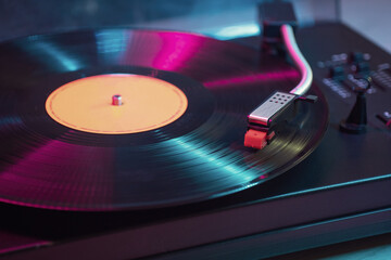 Vintage vinyl record player is playing sound from LP album.