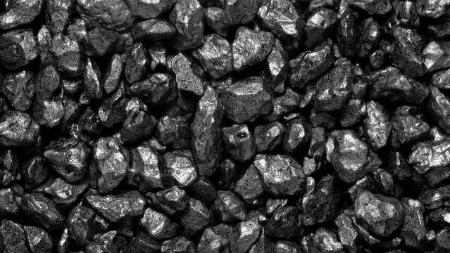 Black stones moving. Close-up of a black stones surface moving.