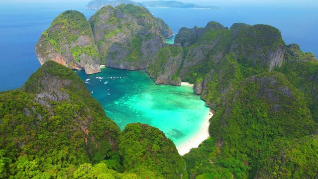 Aerial view over tropical sea, Limestone mountains and crystal clear waters. One of the most beautiful islands in the world. Maya bay, Phi phi island, Krabi, Thailand. Summer background video. 4K
