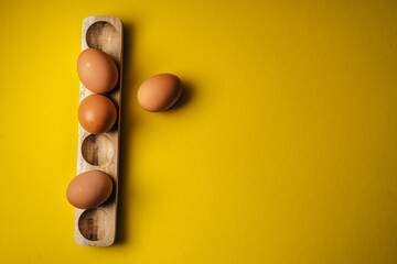 eggs in a box yellow background 