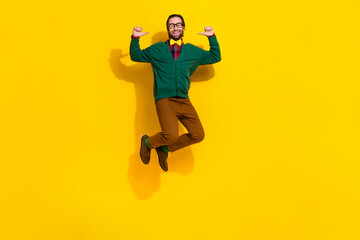 Fototapeta na wymiar Full size portrait of carefree cheerful guy jumping point fingers self himself isolated on yellow color background