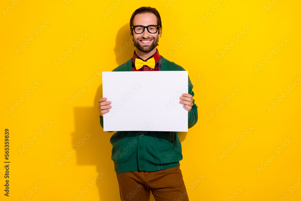 Wall mural Portrait of positive classy man toothy smile arms hold empty space blank isolated on yellow color background - Wall murals