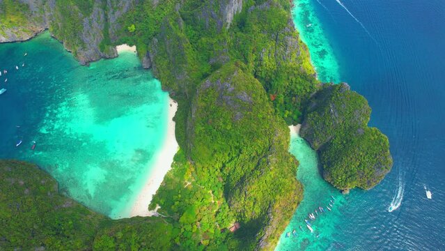 Drone is flying over a magnificent tropical paradise island, Maya bay, Phi phi island, Krabi, Thailand. One of the most beautiful attractions in the world. beach video background. Nature concept. 4K
