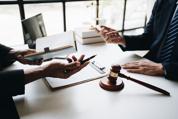 Close up view of professional lawyer explain the details of the contract for his client in office room.