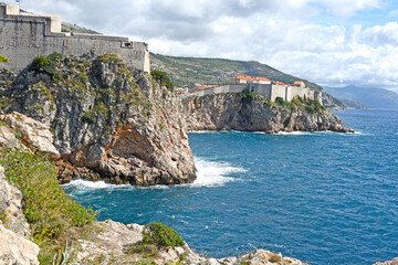 Dubrovnik West Harbor and view to the ancient city wall on the rocks, Dubrovnik, Croatia
