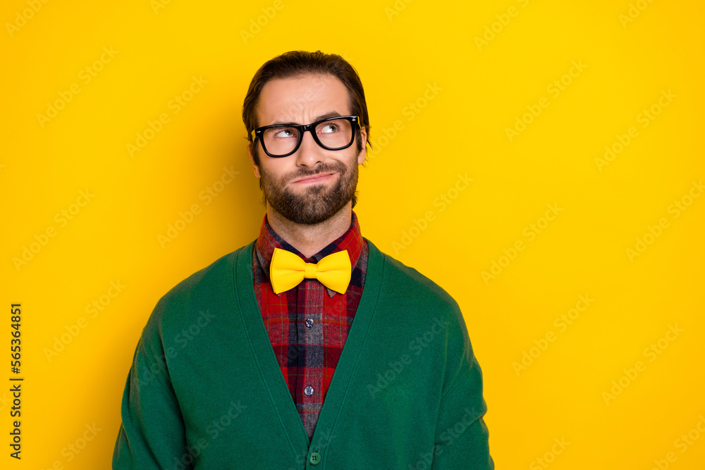 Sticker Photo portrait of young nice guy spectacles look skeptical suspect smirk dressed stylish green clothes isolated on yellow color background