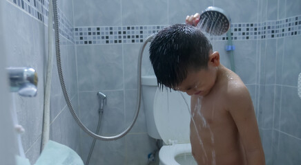 Happy little boy washing head in shower in the bathroom,Happy boy singer under the shower at...